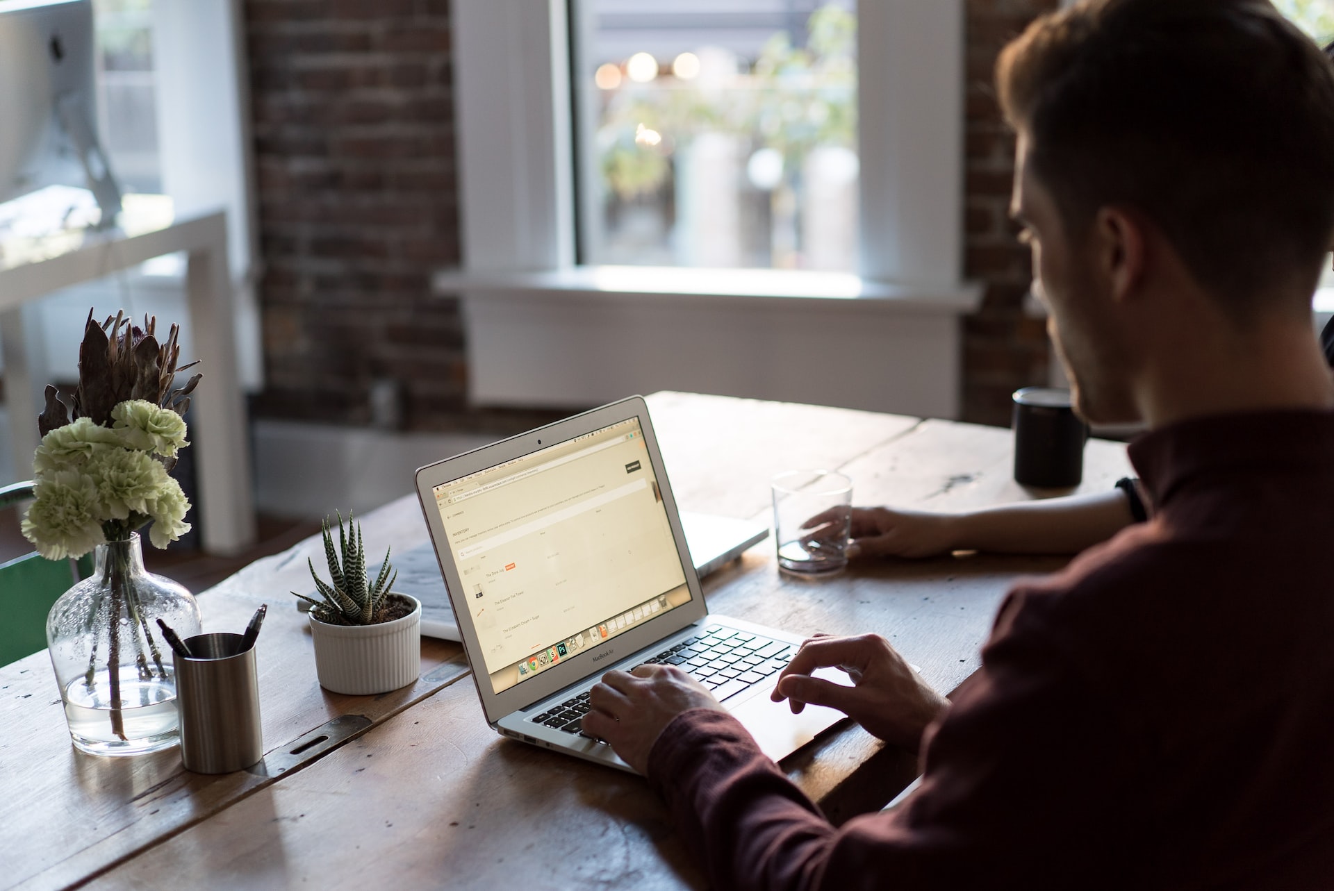 Image showing a man sat at desk browsing a laptop used for executive income protection page